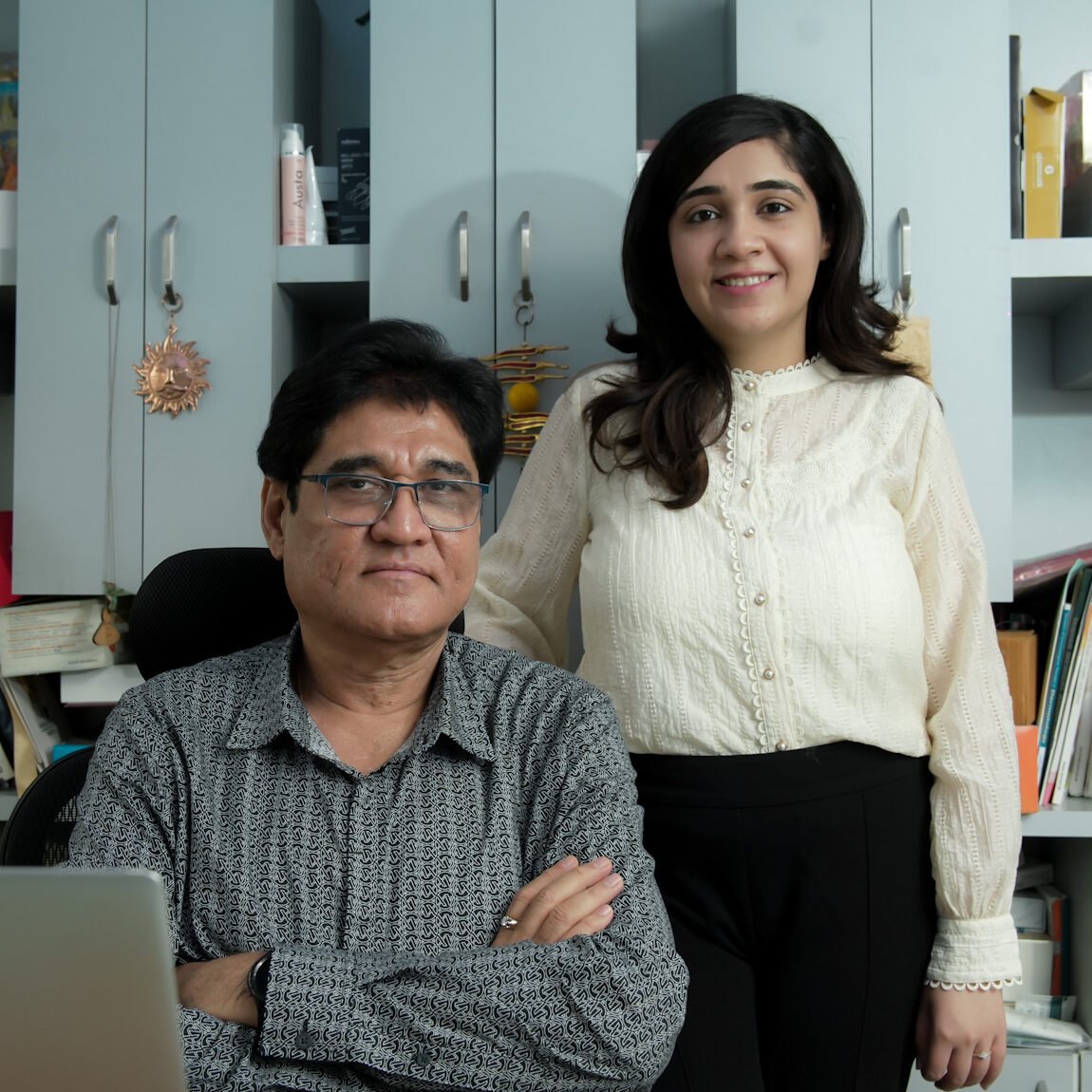 Portrait of Dr. Dilip Hemnani and Dr. Sonal Hemnani, dermatologists at Cosmoderm Laser & Skin Clinic, standing in their clinic office.